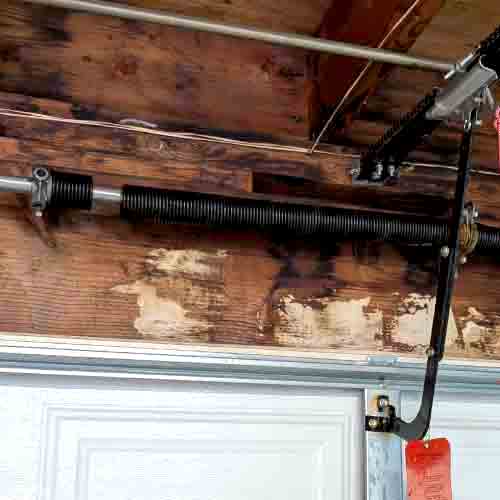 Broken garage door torsion spring identified during a residential inspection in Orange County