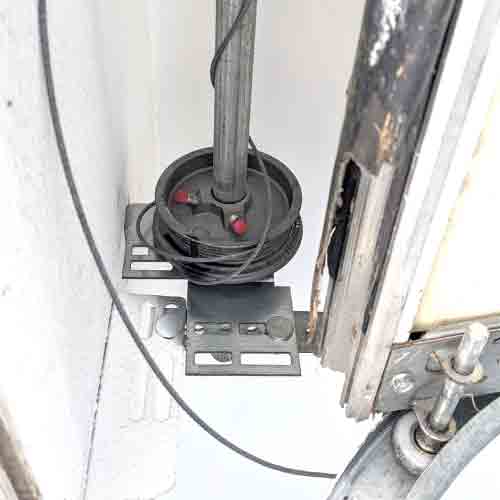 garage door cable that has come loose and wrapped incorrectly around the cable drum