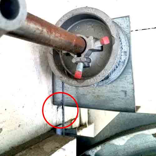 worn garage door cable still under heavy spring tension