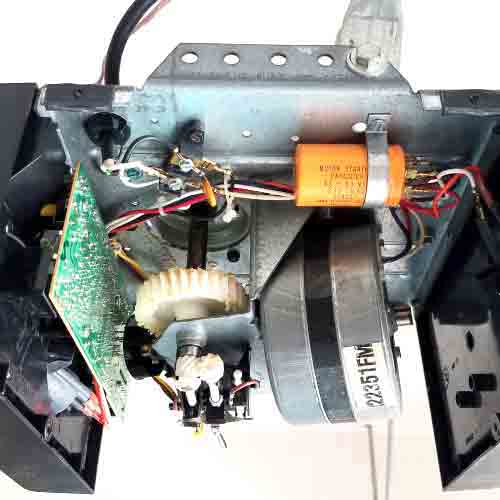 Technician inspecting a malfunctioning garage door opener during a residential service visit in Orange County