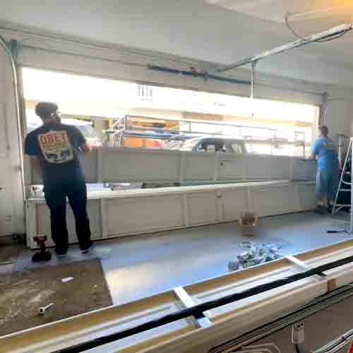 Two uniformed technicians performing a complete structural repair and safety check