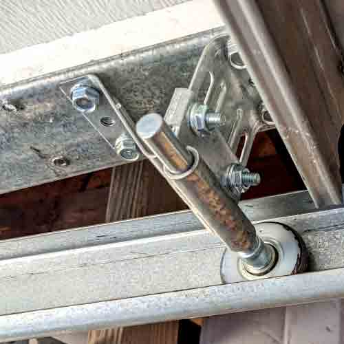 new ball bearing roller replaced and installed into the track and hinge assembly