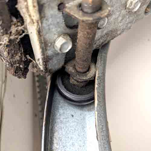 worn garage door roller showing why the component needs replacement
