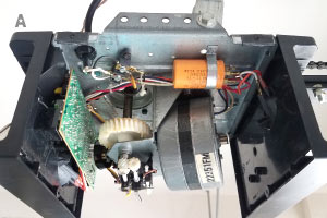 Automatic opener being inspected during a garage door opener repair in Huntington Beach