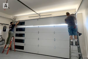 Emergency garage door technicians performing service in Huntington Beach