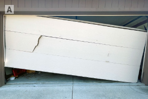 A garage door that has come off the track hangs unevenly
