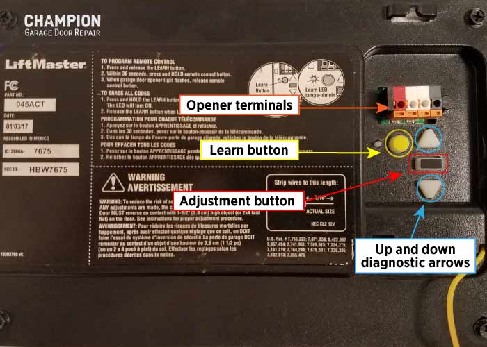 Yellow Learn button with up-and-down diagnostic arrow buttons on a garage door opener control panel
