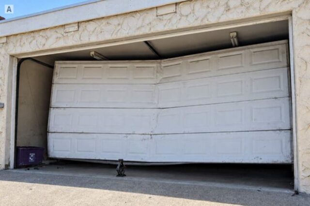 Bent Garage Door Sections After Going Off Track Garage door buckled and stuck crooked