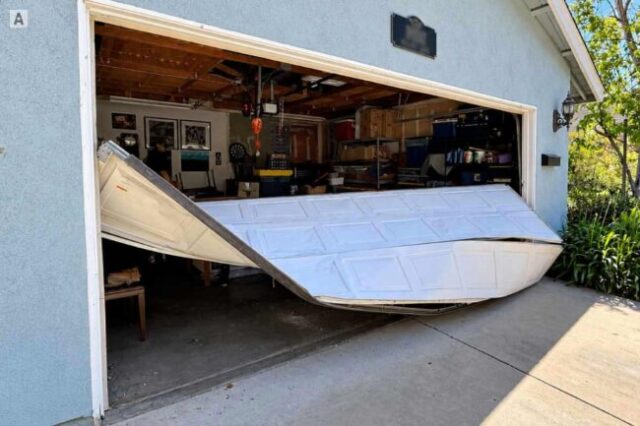 Buckled Garage Door After Coming Off Track Buckled garage door hanging out of position