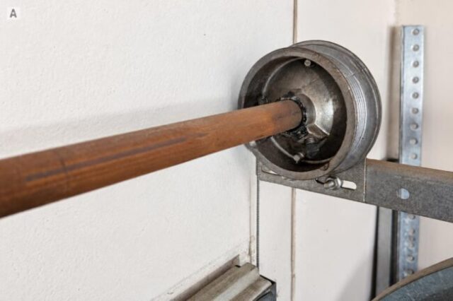 Garage Door Cable and Drum Adjustment Garage door cable and drum assembly being checked for adjustment