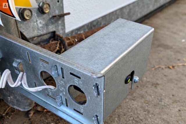 Garage Door Safety Sensor Inspection Garage door photo-eye safety sensor checked during maintenance