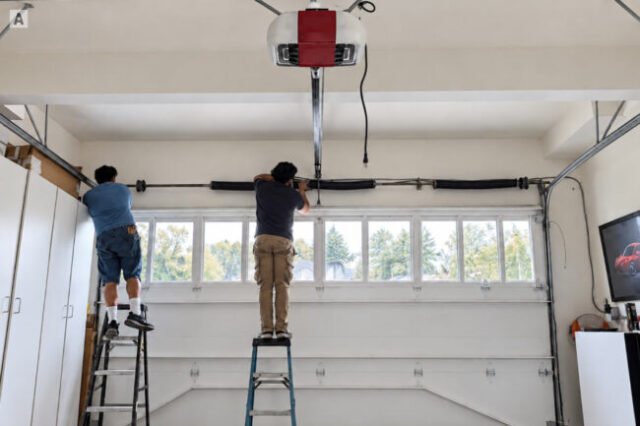 Garage Door Spring Repair in Progress Champion technicians replacing garage door springs in Orange County