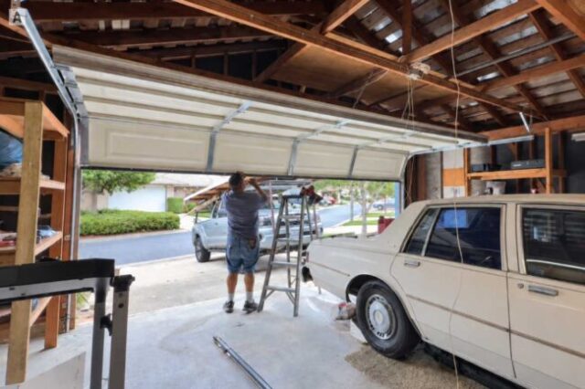 Technician working on the weather seal of a residential garage door.