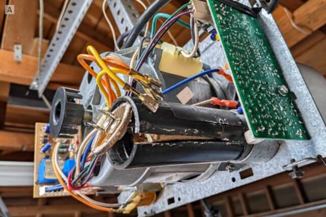 Genie Opener and Capacitor Repair Garage door opener showing the motor, wiring, capacitor, and circuit board