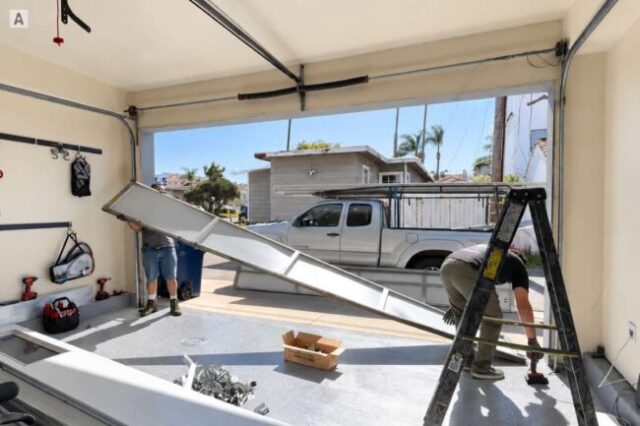 Garage door sections being removed during replacement in Costa Mesa