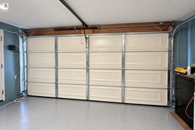New garage door, tracks, springs, and hardware after installation in Huntington Beach