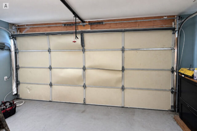 Existing garage door and hardware before replacement in Huntington Beach