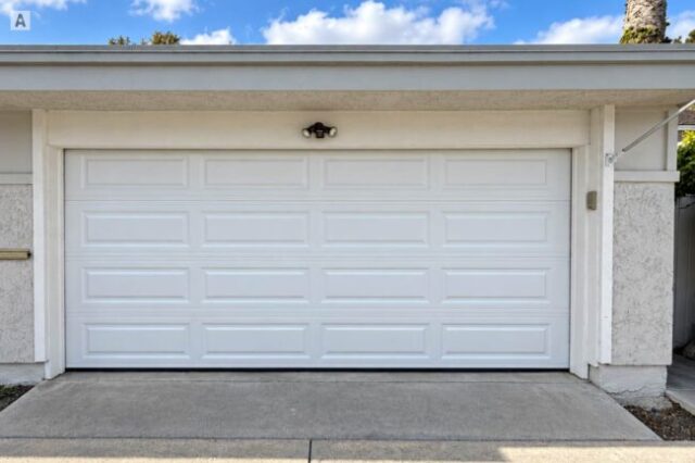 New white sectional garage door after replacement in Westminster