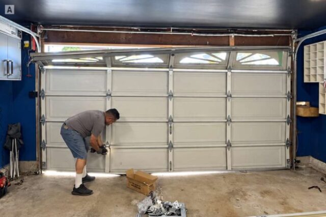 Damaged garage door before replacement in Westminster