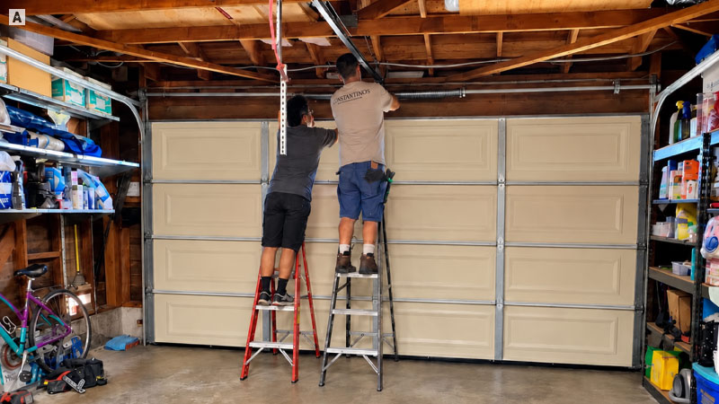 Champion technicians working on the overhead garage door in Huntington Beach